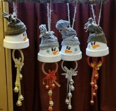 four snowman bells hanging from the ceiling