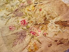 an old bed covered in floral fabric with pink flowers on it