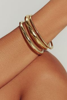 A modern essential, our 18K gold-filled open cuff has the perfect weight and thickness for everyday wear. Layer with our varying widths and finishes for an architectural stack. Jewelry Collection Handcrafted in Brazil 18K Gold Filled Thickness: 5.8mm Inner Diameter: 2.5" Opening: 1.25" Weight: 0.36 oz Waterproof Hypoallergenic Tan Skin Gold Jewelry, Gold Hoop Bracelet, Gold Necklace And Bracelet, Chunky Gold Bangle, Dainty Gold Jewelry Bracelets, Gold Bracelet Thick, Gold Bracelets Bangles, Big Gold Bangles, Gold Jewelry Display