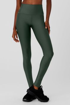 a woman in dark green leggings and sports bra