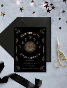 a black and gold save the date card next to scissors, ribbon and star decorations