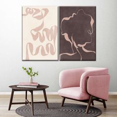 two abstract paintings hang on the wall above a pink chair and coffee table in a living room