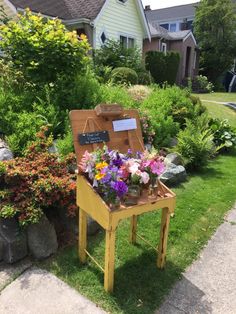 a small wooden table with flowers on it