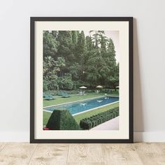 an image of a pool in the middle of a garden with lawn chairs and umbrellas