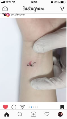 someone is getting a tiny tattoo on their left arm, and it looks like they are holding