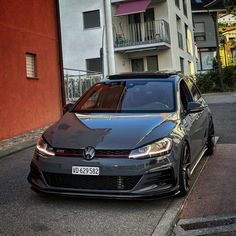 a grey car parked on the side of a street