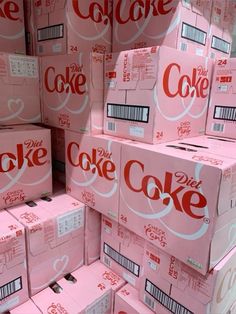 pink boxes stacked on top of each other with the word diet coke written on them