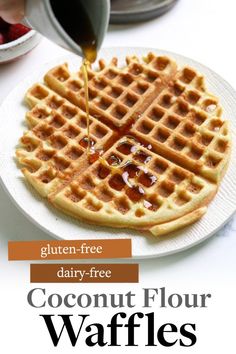 a waffle is being drizzled with syrup from a spoon on a white plate