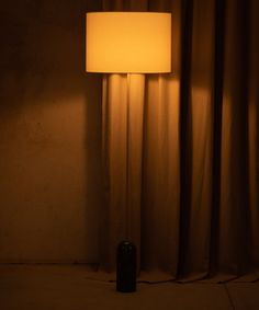 a lamp that is next to a curtain