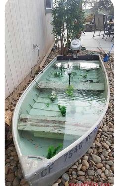 a small boat sitting on top of a pile of rocks