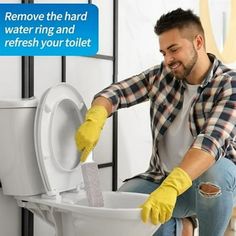 a man cleaning a toilet with yellow gloves