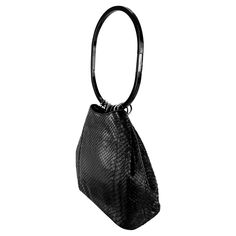 This exquisite bucket bag from Gucci's Fall/Winter 1999 collection, designed by Tom Ford, is crafted entirely from genuine python skin. It features a sleek lucite hoop handle, attached by silver metal rings, with a silver-plated brand plate. This bag made its debut on the season's runway. A grey velvet version and a black leather version were highlighted in the season's ad campaign, modeled by Liisa Winkler and photographed by Mario Testino. The interior includes a small pocket. Approximate Meas Tom Ford Runway, Gucci By Tom Ford, Tom Ford Bag, Vintage Evening Bags, Hermes Kelly Bag, Acrylic Ring, Python Skin, Mario Testino, Gingham Fabric