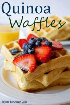 a plate with waffles topped with strawberries and blueberries