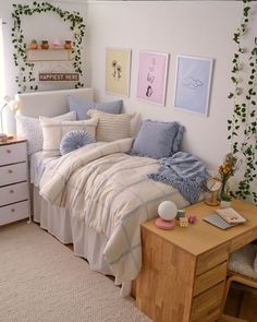 a bed sitting in a bedroom next to a wooden dresser and white wall with ivy growing on it