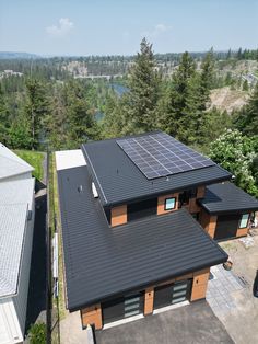 two houses with solar panels on the roof and trees in the backgrouds