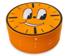 an orange alarm clock with a smiley face on it's face and eyes painted black