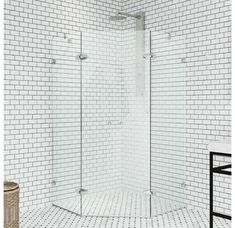 a white tiled bathroom with a stand up shower