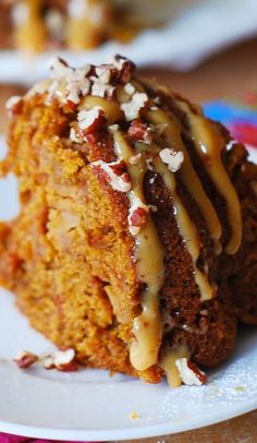 a piece of cake on a plate with icing drizzled over it