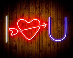 a neon sign that says u with a heart and arrow in the shape of a heart