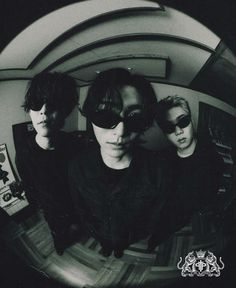 three young men are standing in front of a mirror with their sunglasses on and looking at the camera