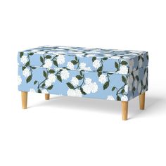 an upholstered blue and white floral bench with wooden legs, designed to look like flowers