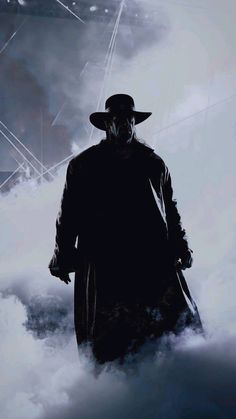 a man in a long coat and hat walking through the clouds with a large mask on his face