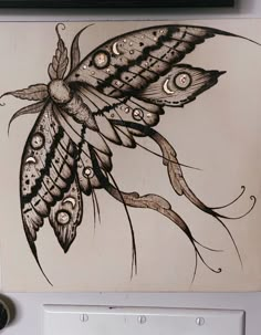 a drawing of a butterfly on a wall