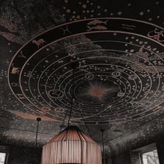 the ceiling is decorated with stars and other things on it, including a light fixture