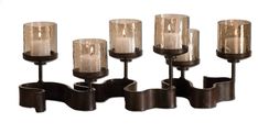 a set of six candles sitting next to each other on a wall mounted candle holder