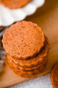 a stack of cookies sitting on top of a wooden cutting board