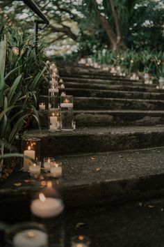 candles are lined up on the steps outside