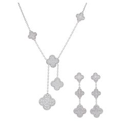 Van Cleef & Arpels Diamond Magic Alhambra Necklace And Earrings Set Crafted In 18k White Gold. Necklace features six Alhambra motifs of various sizes (3x15mm, 2x20.5mm & 1x26mm), encrusted with total of 182 of round brilliant cut diamonds with weight of approximately 6.20ct, .Equipped with lobster claps. Inscribed: VCA, Au750, JExxxxx. Stamped with French hallmark. Length around the neck: 16.5 inches, with jump ring at 15 inches. Length of the drop: 3 inches. Van Cleef & Arpels Magic Alhambra pendant earrings feature six Alhambra motifs, 4 smaller (15mm) and 2 larger20mm), encrusted with total of 158 round brilliant cut diamonds with weight of approx. 4.25ct, Equipped with French clip and removable posts. Inscribed: VCA, Au750, JExxxxx, OR. Stamped with French hallmarks and makers marks. L Van Cleef And Arpels Jewelry Set, Van Cleef And Arpels Jewelry Necklace, Vca Alhambra Necklace, Van Cleef Arpels Necklace White Gold, Magic Alhambra Necklace, Van Cleef And Arpels Sweet Alhambra Necklace, Van Cleef Arpels Sweet Alhambra Necklace White Gold, Alhambra Necklace, Van Cleef Arpels Diamond