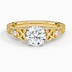 a yellow gold engagement ring with a round diamond in the center