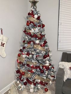 a christmas tree decorated with red, white and silver ornaments