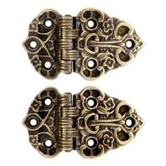 two antique brass plated door handles with ornate designs on each side and one has an open