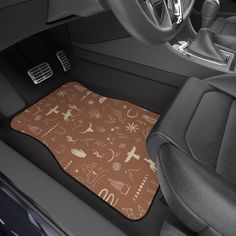 the interior of a car with an area rug for floor mats that have various symbols on them