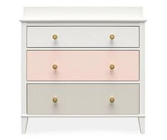 a white and pink chest of drawers with gold knobs on the bottom, against a white background