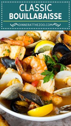 a white bowl filled with seafood and mussels, garnished with parsley