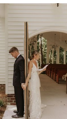 a bride and groom standing in front of the alter at their wedding ceremony, holding hands with each other