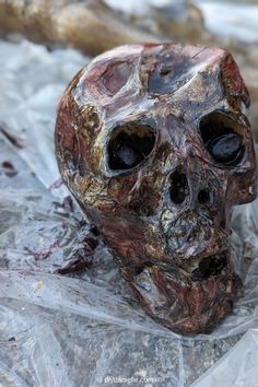 a skull statue sitting on top of plastic wrap