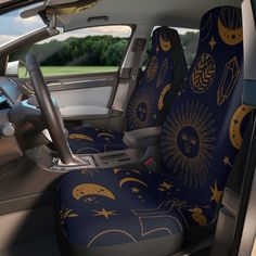 the interior of a car with sun, moon and stars all over it's seat covers