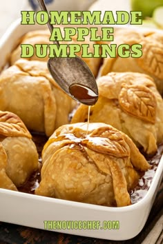 homemade apple dumplings in a baking dish with caramel sauce being drizzled over them