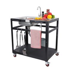 a kitchen cart with a sink and some utensils on it's wheels