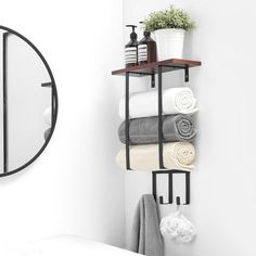 a shelf with towels and soaps on it next to a mirror