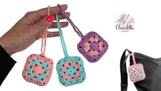 three crocheted purses are being held by someone's hand and the bag is next to them