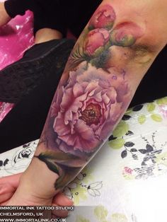 a person with a flower tattoo on their arm