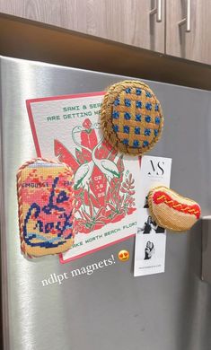 magnets on the side of a refrigerator with hot dogs and buns attached to it