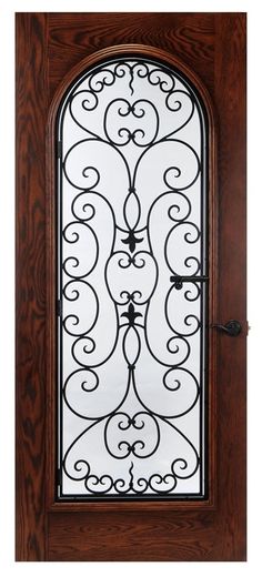 a wooden door with wrought iron design on the front and side glass paneled in brown wood