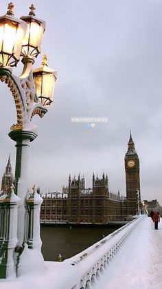 the big ben clock tower towering over the city of london covered in snow