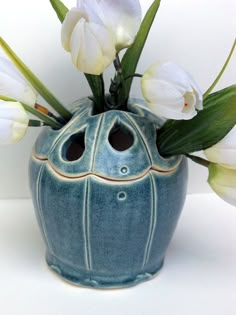 a blue vase with white flowers in it